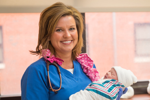 A woman holding an infant.