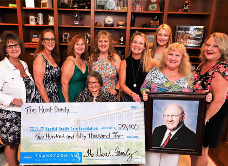 The Hunt family donating a check for 250k.